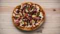 Delicious Devilled Chicken Pizza on a wooden surface overhead top view close-up photograph. mozzarella cheese and lots of spices