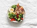 Delicious diet lunch, breakfast - boiled egg, fresh vegetable salad, broccoli and hot sandwiches with tomato and cheese on a light Royalty Free Stock Photo