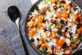 Delicious dietary rice with sweet potatoes, nuts, pecans, onions and dried cranberries close-up in a bowl. Horizontal top view