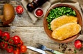 Delicious dinner chicken schnitzel with cheese lettuce salad wit Royalty Free Stock Photo