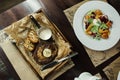 Delicious dinner table with grilled steak with butter and salmon salad and mixed vegetables. The concept of a healthy dinner. View