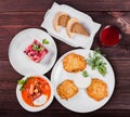 Delicious dinner table with potato pancakes, traditional beetroot soup - borscht with beef, beet salad Vinaigrette. Royalty Free Stock Photo