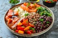 A delicious dish with salmon, beans, rice, and peppers served on a table