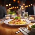 a delicious dish of homemade spaguetti carbonara on a plate on a table in an italian restaurant Royalty Free Stock Photo