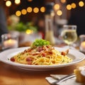 a delicious dish of homemade spaguetti carbonara on a plate on a table in an italian restaurant Royalty Free Stock Photo