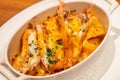 The delicious dish named Langoustine gratin. Langoustines look similar to miniature lobsters, and this creamy gratin is elevated . Royalty Free Stock Photo