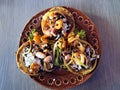 Delicious dish of Sopes and seafood tostadas that are a fried tortilla with beans, shrimp and octopus on top Royalty Free Stock Photo