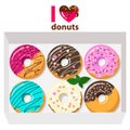 Delicious donuts in box on white background with letters: i love donuts.
