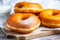 TDelicious donuts with powdered sugar on wooden table Royalty Free Stock Photo