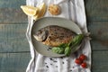 Delicious dorado fish with basil and spices served on wooden table, flat lay