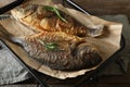 Delicious dorado fish with rosemary on wooden table, closeup