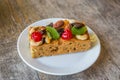 Delicious dried fruit cake with almond and cashew nut on white plate Royalty Free Stock Photo