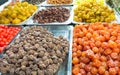 Close-up of delicious dried fruits neatly displayed on wholesale market trays. Merchants sell dried fruits in Asia