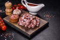 Delicious dry sausage with walnuts on a concrete table. Dry cured fuet sausage on a dark background Royalty Free Stock Photo