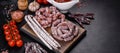 Delicious dry sausage with walnuts on a concrete table. Dry cured fuet sausage on a dark background Royalty Free Stock Photo