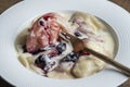 Delicious dumplings stuffed with cottage cheese with sour cream and cherry jam in a white plate, closeup. Ukrainian cuisine Royalty Free Stock Photo