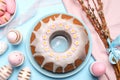 Delicious Easter cake decorated with sprinkles near painted eggs and willow branches on light blue background, flat lay Royalty Free Stock Photo