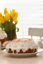 Delicious Easter cake decorated with sprinkles on white wooden table