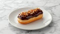 Delicious Eclair with Chocolate Glaze and Nuts on a White Plate Tasty Treat Royalty Free Stock Photo