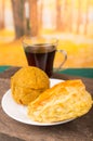 Delicious ecuadorian breakfast, empanada y bolon with dark coffee