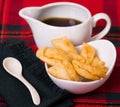 Delicious ecuadorian pristinos piled up in bowl, traditional andean pastry, cheese platter and coffee cup sitting