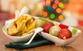 Delicious ecuadorian pristinos piled up in bowl, traditional andean pastry, fruit platter sitting besides