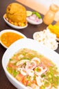 Delicious ecuadorin ceviche of squid with spicy sauce and behind bolon and popcorn