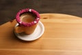 Delicious edible biscuit cup of coffee decorated with sprinkles on wooden table. Space for text