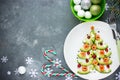 Delicious edible Christmas tree from avocado slices, salty salmon, cranberry and boiled egg stars Royalty Free Stock Photo
