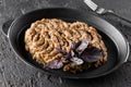 Delicious eggplant salad on a large plate, dark background, top view. Healthy vegan food, clean eating Royalty Free Stock Photo