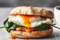 Delicious English muffin breakfast sandwich with crunchy chicken sautÃ©ed spinach fried egg and sauce Royalty Free Stock Photo