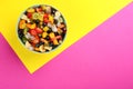 Delicious exotic fruit salad on color background, top view. Space for text Royalty Free Stock Photo