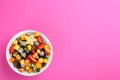 Delicious exotic fruit salad on pink background, top view. Space for text Royalty Free Stock Photo