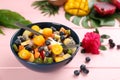 Delicious exotic fruit salad on pink wooden table Royalty Free Stock Photo