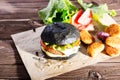 Delicious fast food. Tasty burger with bacon on table against black background. Space for text Royalty Free Stock Photo