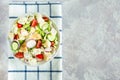 Delicious fattoush salad with bread pita, fresh vegetables and basil on plate. Traditional middle eastern or arabic food. Close up