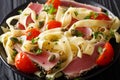 Delicious fettuccine pasta with tuna steak, tomatoes and capers Royalty Free Stock Photo