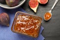 Delicious fig jam and fresh fruits on black table, flat lay Royalty Free Stock Photo