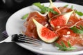 Delicious figs and proscuitto on plate, closeup Royalty Free Stock Photo