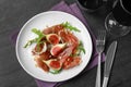 Delicious figs and proscuitto on plate, flat lay Royalty Free Stock Photo