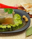 Delicious fish aspic on white plate with mustard and green salad Royalty Free Stock Photo