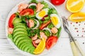 Delicious fish salad salmon or tuna with lettuce, tomatoes, red onion, eggs and avocado with dressing of olive oil , mustard and Royalty Free Stock Photo