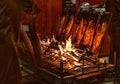 Delicious flamed Salmon is smoked on open fire at Christmas market