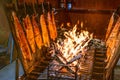 Delicious flamed Salmon is smoked on open fire at Christmas market