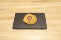 Delicious fluffy cookie with chocolate inside on a black slate plate Royalty Free Stock Photo