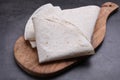 Delicious folded Armenian lavash on dark table