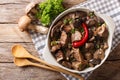 Delicious food: beef stew with wild mushrooms in spicy sauce close-up in a bowl. Horizontal top view Royalty Free Stock Photo