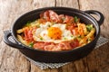 Delicious food fried egg with French fries and jamon close-up in a plate. Horizontal Royalty Free Stock Photo