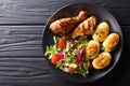 Delicious food: grilled chicken drumsticks with new potatoes and Royalty Free Stock Photo