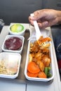 Delicious food served on board of economy class airplane on the table Royalty Free Stock Photo